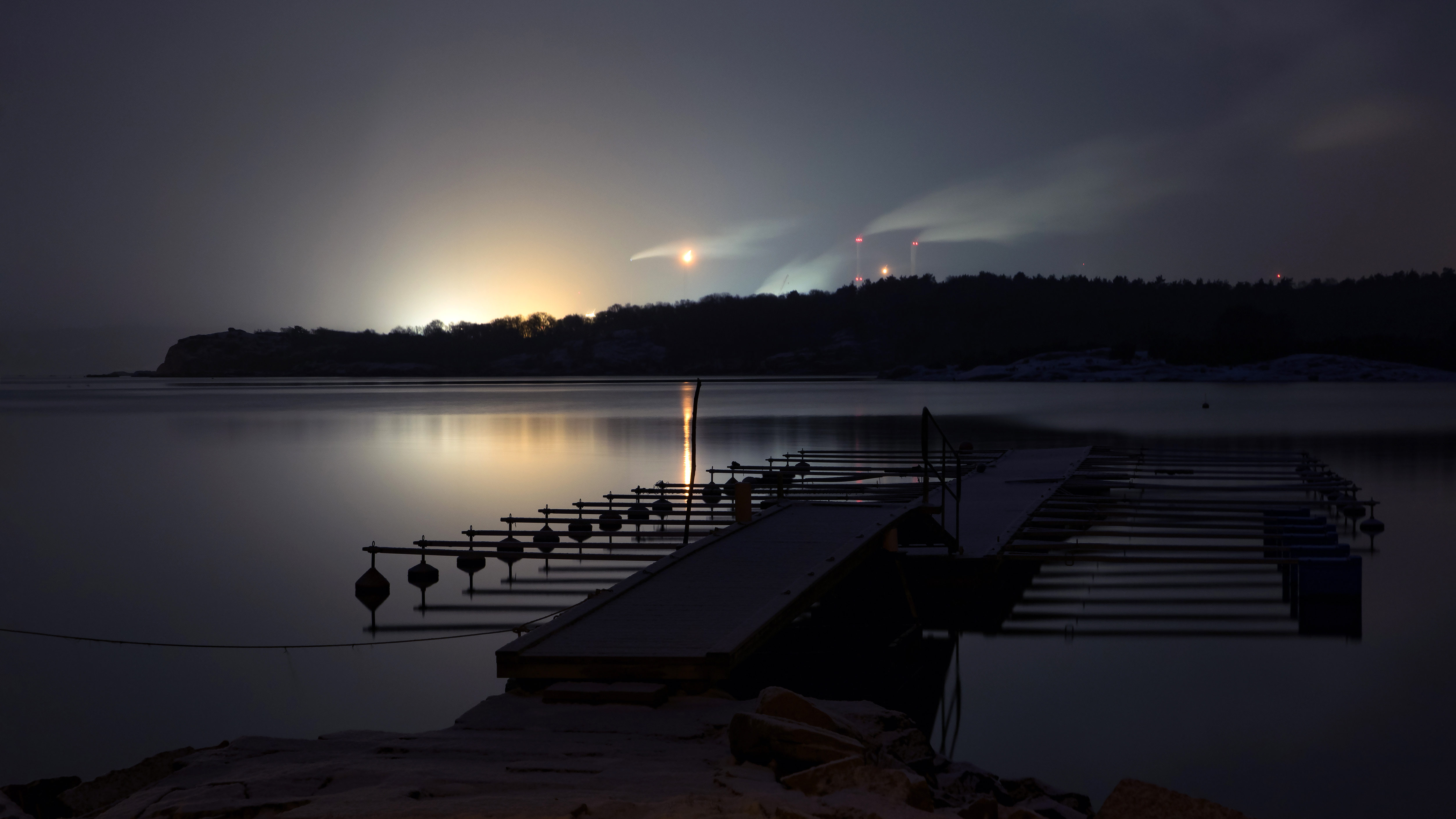 An oil refinery with storage tanks at dusk